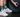 Person at the gym wearing OUTWAY athletic crew socks with geometric mountain pattern next to a weight plate