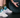 Person at the gym wearing OUTWAY athletic crew socks with geometric mountain pattern next to a weight plate