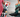 Two pairs of colorful knee-high socks. On the left, a cream sock featuring a Japanese-inspired design with cats, trees, and a red sun. On the right, a person wearing teal and grey socks with a mountain and forest landscape design.