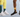 Two people wearing colourful OUTWAY crew socks, one in a teal mountain forest design with white sneakers and one in a yellow sunset landscape design with black sneakers, shown from the waist down against a light blue background