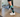 Person walking indoors wearing OUTWAY knee high compression socks with green and black mountain pattern