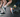 Two runners on road and trail wearing OUTWAY crew socks, one in white retro stripe design and one in a colourful nature print, shown from the knees down mid-stride.