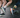 Two runners on road and trail wearing OUTWAY crew socks, one in white retro stripe design and one in a colourful nature print, shown from the knees down mid-stride.